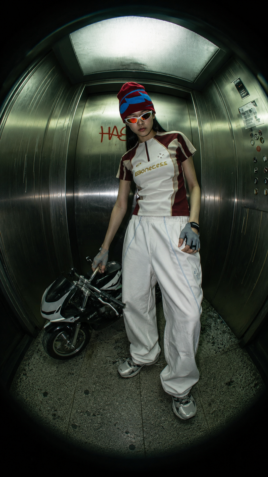 Boneless fashion campaign portrait with a miniature motorcycle